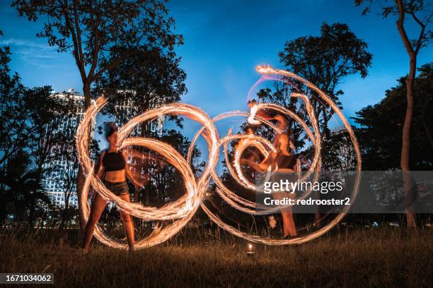 fire dancers at an urban park - hot vietnamese women stock pictures, royalty-free photos & images