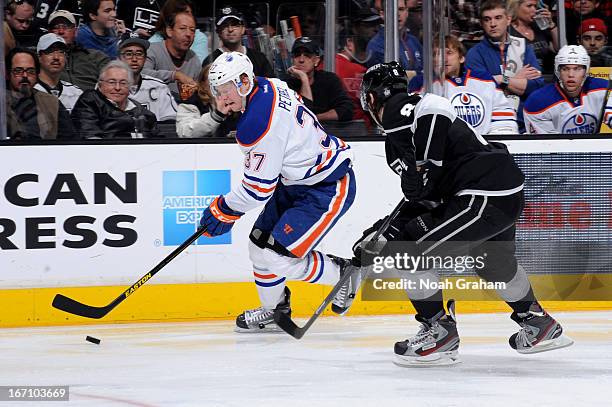 Lennart Petrell of the Edmonton Oilers skates with the puck against Drew Doughty of the Los Angeles Kings at Staples Center on April 6, 2013 in Los...