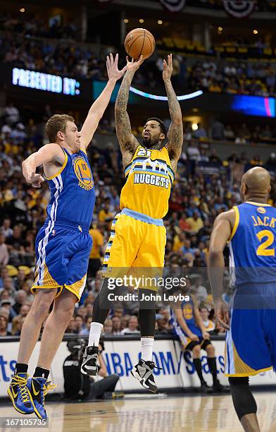Denver Nuggets shooting guard Wilson Chandler shoots over Golden State Warriors power forward David Lee in the first quarter. The Denver Nuggets took...