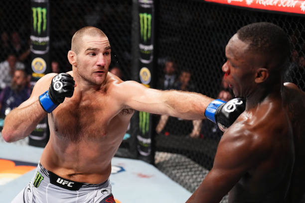 Sean Strickland punches Israel Adesanya of Nigeria in the UFC middleweight championship fight during the UFC 293 event at Qudos Bank Arena on...