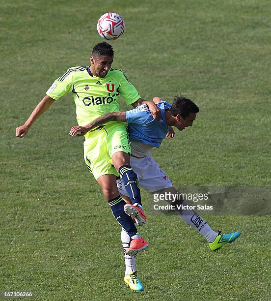Osvaldo Gonzalez of Universidad de Chile, struggles for the ball with Carlos Escobar of O'Higgins during a match between Universidad de Chile and...