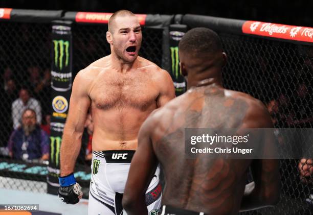 Sean Strickland taunts Israel Adesanya of Nigeria in the closing moments of their UFC middleweight championship fight during the UFC 293 event at...