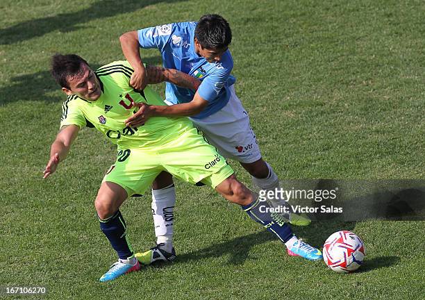 Clarence Acua of Universidad de Chile, struggles for the ball with Braulio Leal of O'Higgins during a match between Universidad de Chile and...