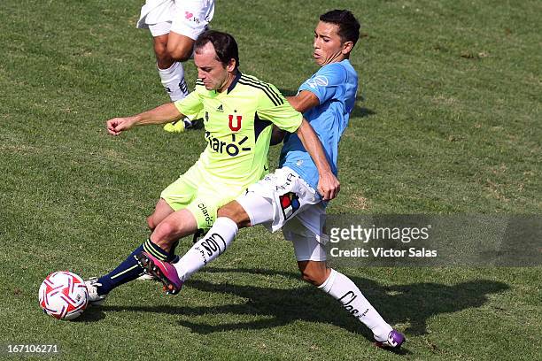 Gustavo lorenzetti of Universidad de Chile, struggles for the ball with Cristian Cuevas of O'Higgins during a match between Universidad de Chile and...