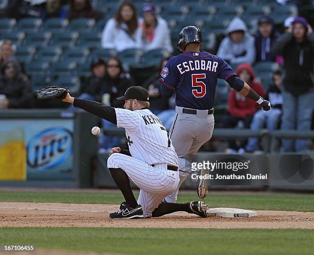 Jeff Keppinger of the Chicago White Sox misses a throw for an error on teammate Alexei Ramirez as Eduardo Escobar of the Minnesota Twins crosses...