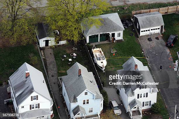 Investigators work around the boat where Dzhokhar A. Tsarnaev was found hiding after a massive manhunt, in the backyard of a Franklin Street home, in...