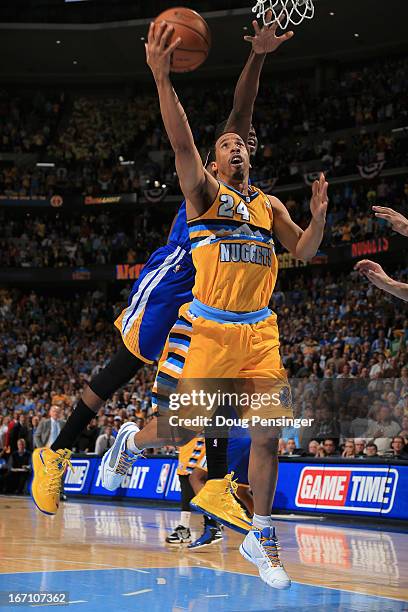 Andre Miller of the Denver Nuggets lays in the game winning shot against Draymond Green of the Golden State Warriors with 1.2 seconds remaining in...