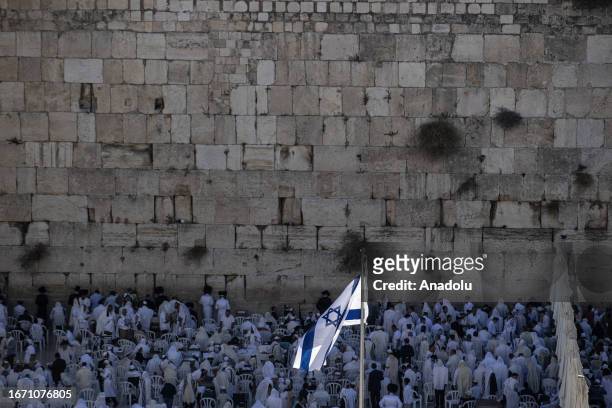 Israeli settlers pray in front of Western Wall with Torah as they stormed Al-Aqsa Mosque during Rosh Hashanah, the Jewish New Year in Old City of...