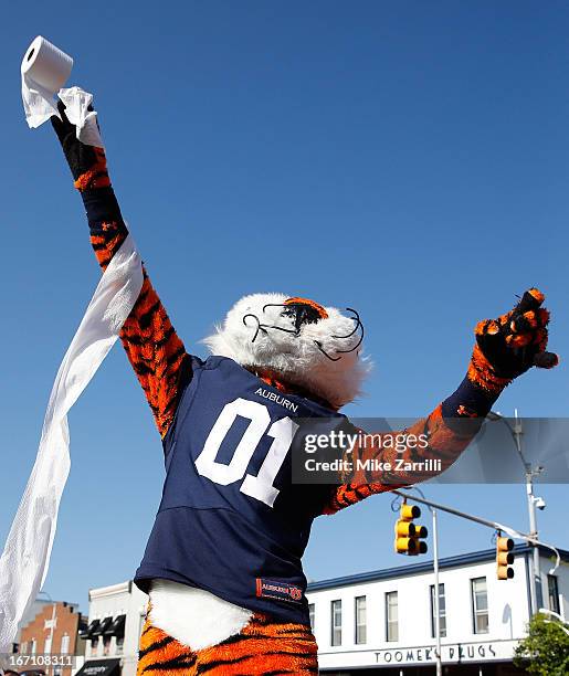 Auburn mascot Aubie throws a roll of toilet paper at the Auburn Oaks during the Toomer's Corner Celebration on April 20, 2013 in Auburn, Alabama.