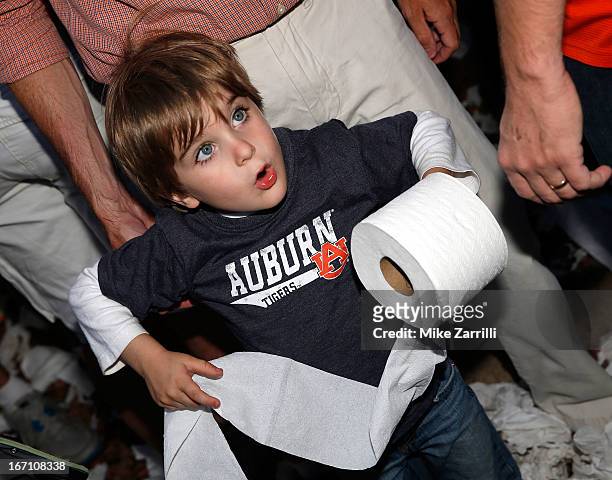 Young Auburn fan gets ready to throw a roll of toilet paper at the Auburn Oaks during the Toomer's Corner Celebration on April 20, 2013 in Auburn,...