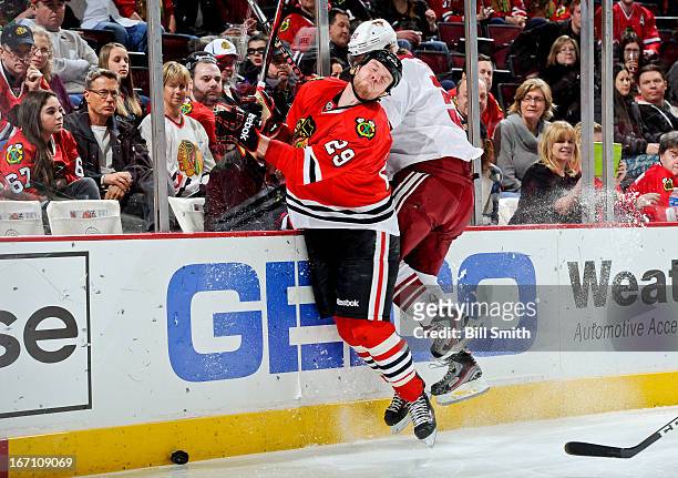 Antoine Vermette of the Phoenix Coyotes gets called for high-sticking against Bryan Bickell of the Chicago Blackhawks during the NHL game on April...