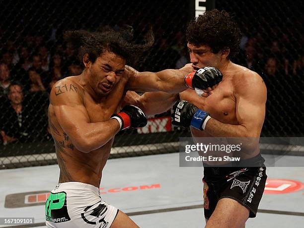 Gilbert Melendez punches Benson Henderson in their lightweight championship bout during the UFC on FOX event at the HP Pavilion on April 20, 2013 in...