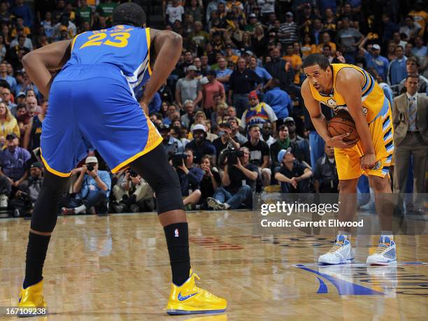 Andre Miller of the Denver Nuggets controls the ball against Draymond Green of the Golden State Warriors in Game One of the Western Conference...