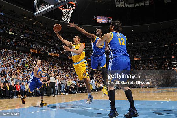 Andre Miller of the Denver Nuggets makes the game winning shot as time expires in the fourth quarter against Draymond Green of the Golden State...