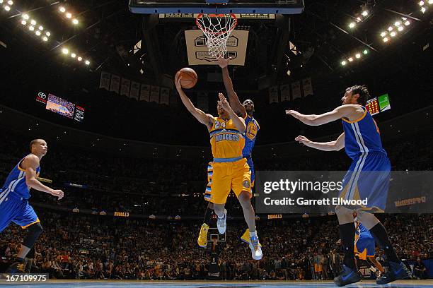 Andre Miller of the Denver Nuggets makes the game winning shot as time expires in the fourth quarter against Draymond Green of the Golden State...