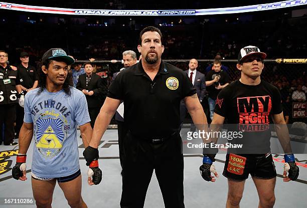 Benson Henderson and Gilbert Melendez await the decision in their lightweight championship bout during the UFC on FOX event at the HP Pavilion on...