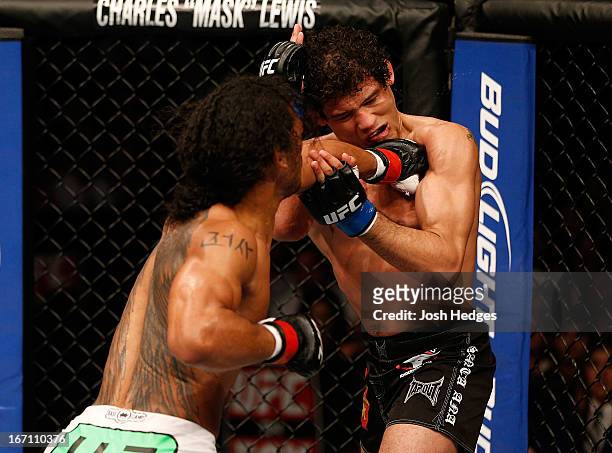 Benson Henderson punches Gilbert Melendez in their lightweight championship bout during the UFC on FOX event during the UFC on FOX event at the HP...
