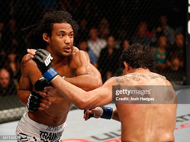 Benson Henderson punches Gilbert Melendez in their lightweight championship bout during the UFC on FOX event during the UFC on FOX event at the HP...