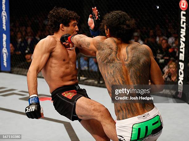 Benson Henderson punches Gilbert Melendez in their lightweight championship bout during the UFC on FOX event during the UFC on FOX event at the HP...