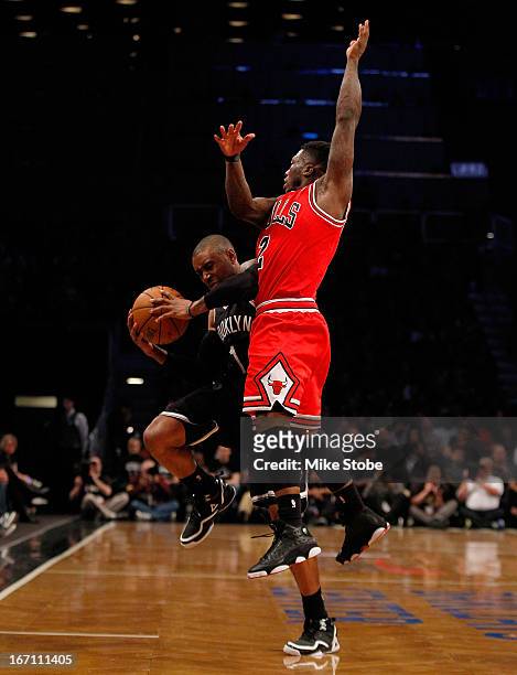 Nate Robinson of the Chicago Bulls defends against C.J. Watson of the Brooklyn Nets during Game One of the Eastern Conference Quarterfinals of the...