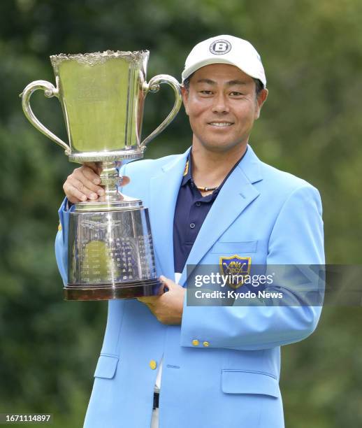 Hideto Tanihara poses with the trophy after winning the ANA Open golf tournament on Sept. 17 at Sapporo Golf Club's Wattsu course in Kitahiroshima in...