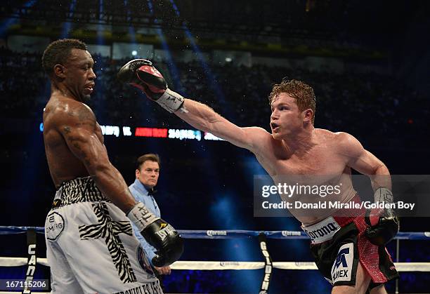 Canelo Alvarez of Mexico lands a punch on Austin Trout of USA en route to Alvarez's unanimous 12-round decision during th WBC, WBA, and Vacant Ring...