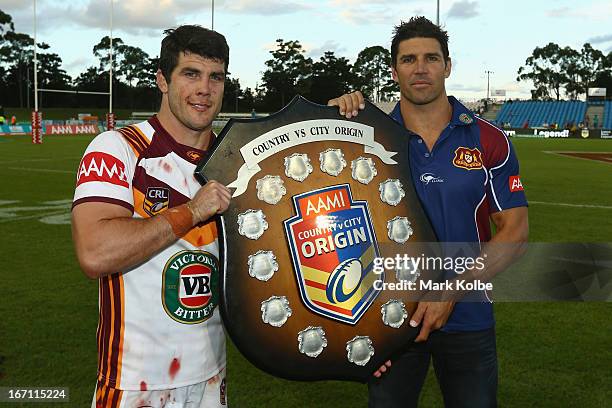 Country captain Michael Ennis and Country coach Trent Barrett pose with the shield after victory in the Origin match between City and Country at BCU...