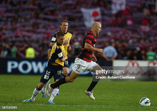 Dino Kresinger of the Wanderers is fouled by Michael McGlinchey of the Mariners during the A-League 2013 Grand Final match between the Western Sydney...