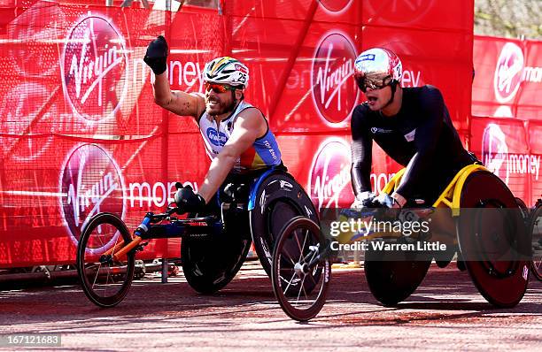 Kurt Fearnley of Australia celebrates victory as he crosses the finish line ahead of Marcel Hug of Switzerland to win the Mens Elite Wheelchair...