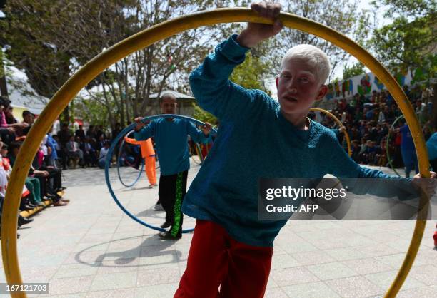 Afghan children from The Mobile Mini Circus for Children take part in a performance to honour "World Circus Day" at their Centre in Kabul on April...