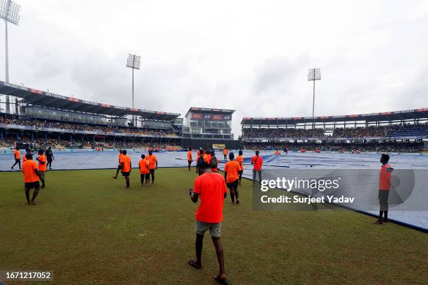 Ground staff cover the field during a rain delay in the Asia Cup Final match between India and Sri Lanka at R. Premadasa Stadium on September 17,...