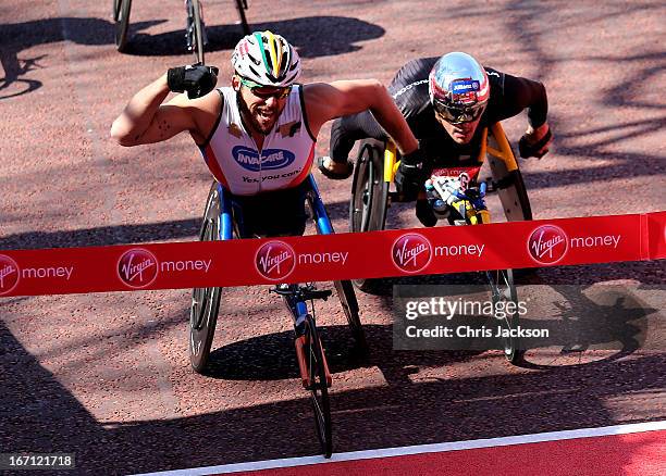 Kurt Fearnley of Australia celebrates victory as he crosses the finish line ahead of Marcel Hug of Switzerland to win the Mens Elite Wheelchair...