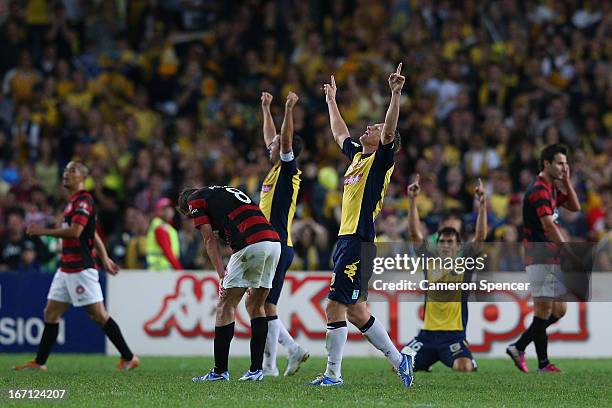 Daniel McBreen of the Mariners and team mates celebrate winning the A-League 2013 Grand Final match between the Western Sydney Wanderers and the...