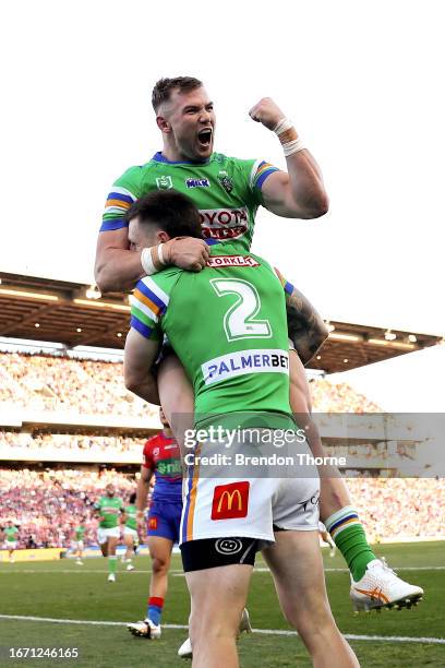 James Schiller of the Raiders celebrates with team mate Hudson Young after scoring a try during the NRL Elimination Final match between Newcastle...