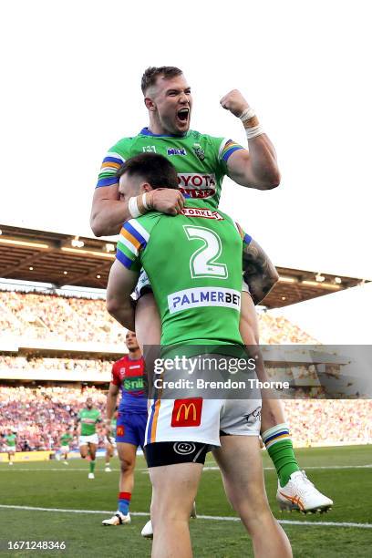 James Schiller of the Raiders celebrates with team mate Hudson Young after scoring a try during the NRL Elimination Final match between Newcastle...