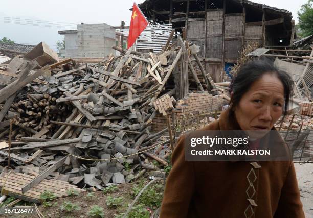 An elderly woman beside the wreckage of her home after a magnitude 7.0 earthquake hit Lushan, Sichuan Province on April 21, 2013. More than 150...