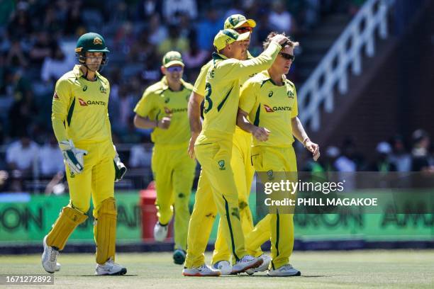 Australia's Marnus Labuschagne celebrates touching the hair of Australia's Adam Zampa after the dismissal of South Africa's Heinrich Klaasen during...