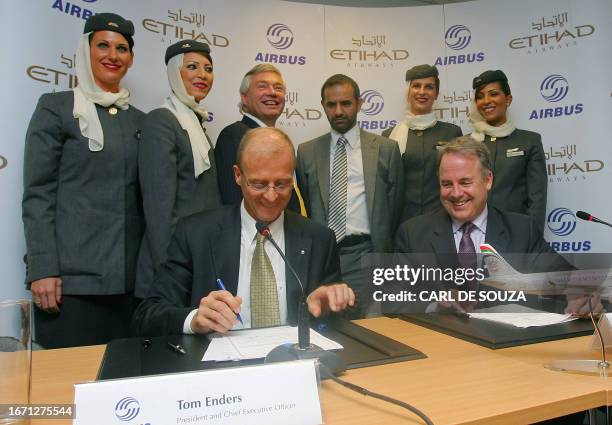 Tom Enders, CEO of Airbus and James Hogan, CEO of Etihad sign contracts during a photocall at Farnborough Airshow, Hampshire on July 14, 2008. Etihad...