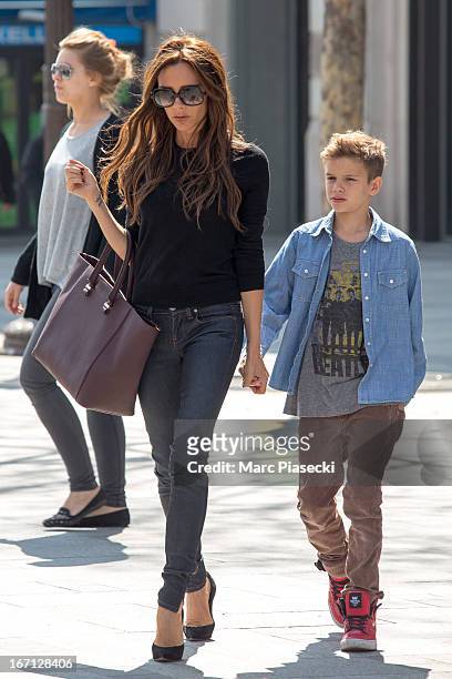 Victoria Beckham and her son Romeo James are seen leaving the 'NIKE' store on the Champs-Elysees Avenue on April 21, 2013 in Paris, France.