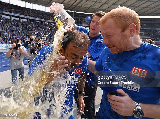 Jos Luhukay, head coach of Berlin gets showered in beer as his team celebrates promotion to the first leage at the end of the second Bundesliga match...