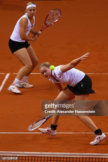 Anna-Lena Groenefeld of Germany plays a forehand with her team mate Sabine Lisicki during her double match against Aleksandra Krunic and Vesna Dolonc...