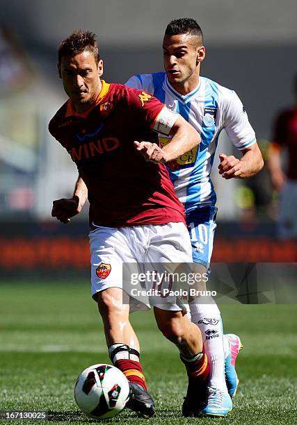 Francesco Totti of AS Roma competes for the ball with Mervan Celik of Pescara during the Serie A match between AS Roma and Pescara at Stadio Olimpico...