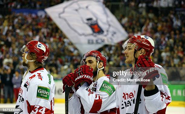 Daniel Tjernqvist, Felix Schuetz and Torsten Ankert of Koeln look dejected after losing in game four of the DEL final play-offs between Eisbaeren...