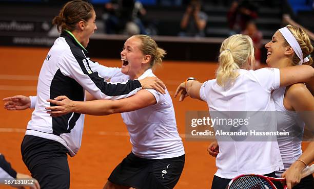 Anna-Lena Groenefeld of Germany celebrates victory with her team mates Andrea Petkovic , Sabine Lisicki and Germany`s team captain Barbara Rittner...