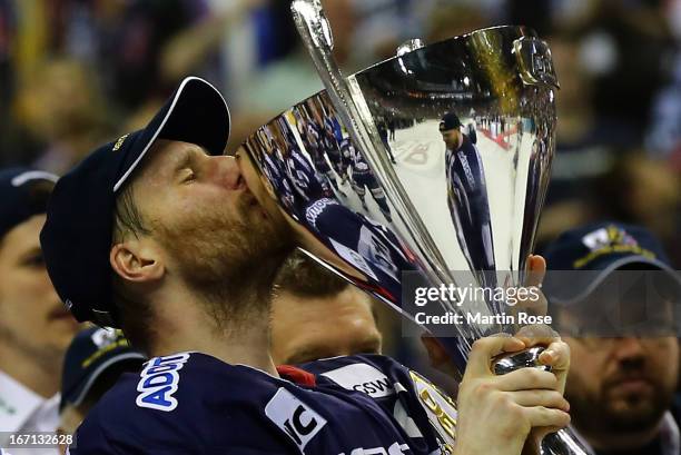 Andre Rankel of Berlin lifts the trophy after winning in game four of the DEL final play-offs between Eisbaeren Berlin and Koelner Haie at o2-world...