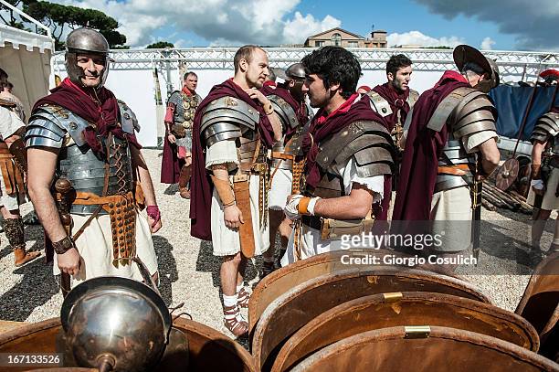 Actors dressed as ancient Roman soldiers get ready to march in a commemorative parade during festivities marking the 2,766th anniversary of the...