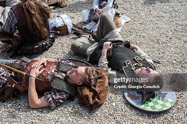 Actors dressed as ancient barbarian soldiers rest before to march in a commemorative parade during festivities marking the 2,766th anniversary of the...