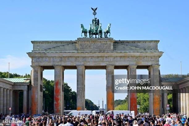The columns of Berlin's landmark the Brandenburg Gate are covered in orange paint on September 17, 2023 in Berlin. Activists of the "Last Generation"...
