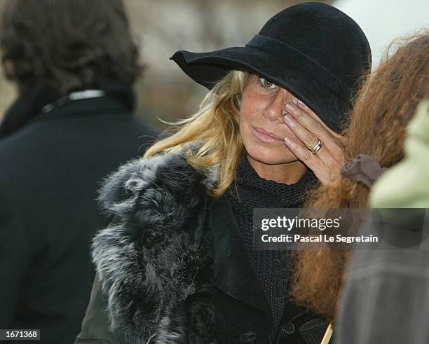 French actress Fiona Gelin wipes a tear as she attends the funeral services for French actor Daniel Gelin December 4, 2002 in Paris. Gelin, known...