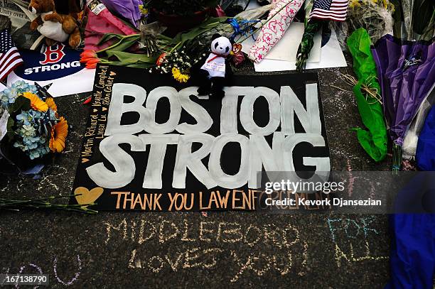 Large sign with the names of the Boston Marathon bombing victims and thanking law enforcement is placed by a Boston Bruins hockey team fan at a...